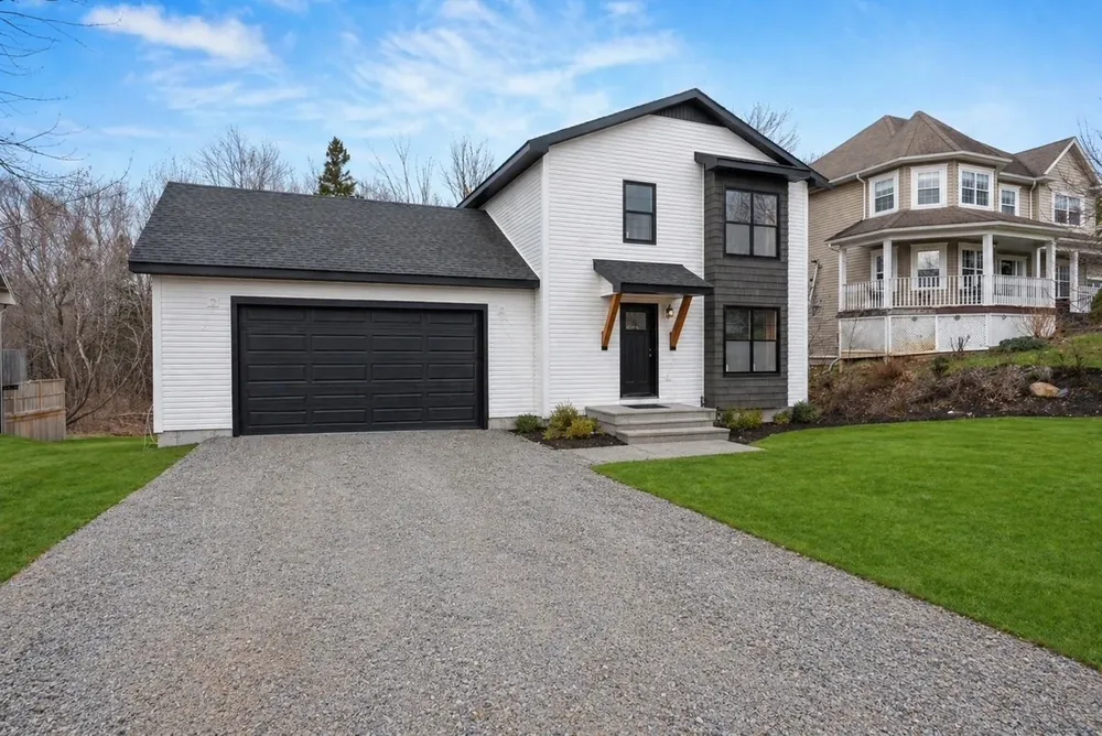 A finished Wildawbren home with attached garage, fresh sod, and a paved driveway, the kind of move-in-ready property we inspect for buyers and sellers